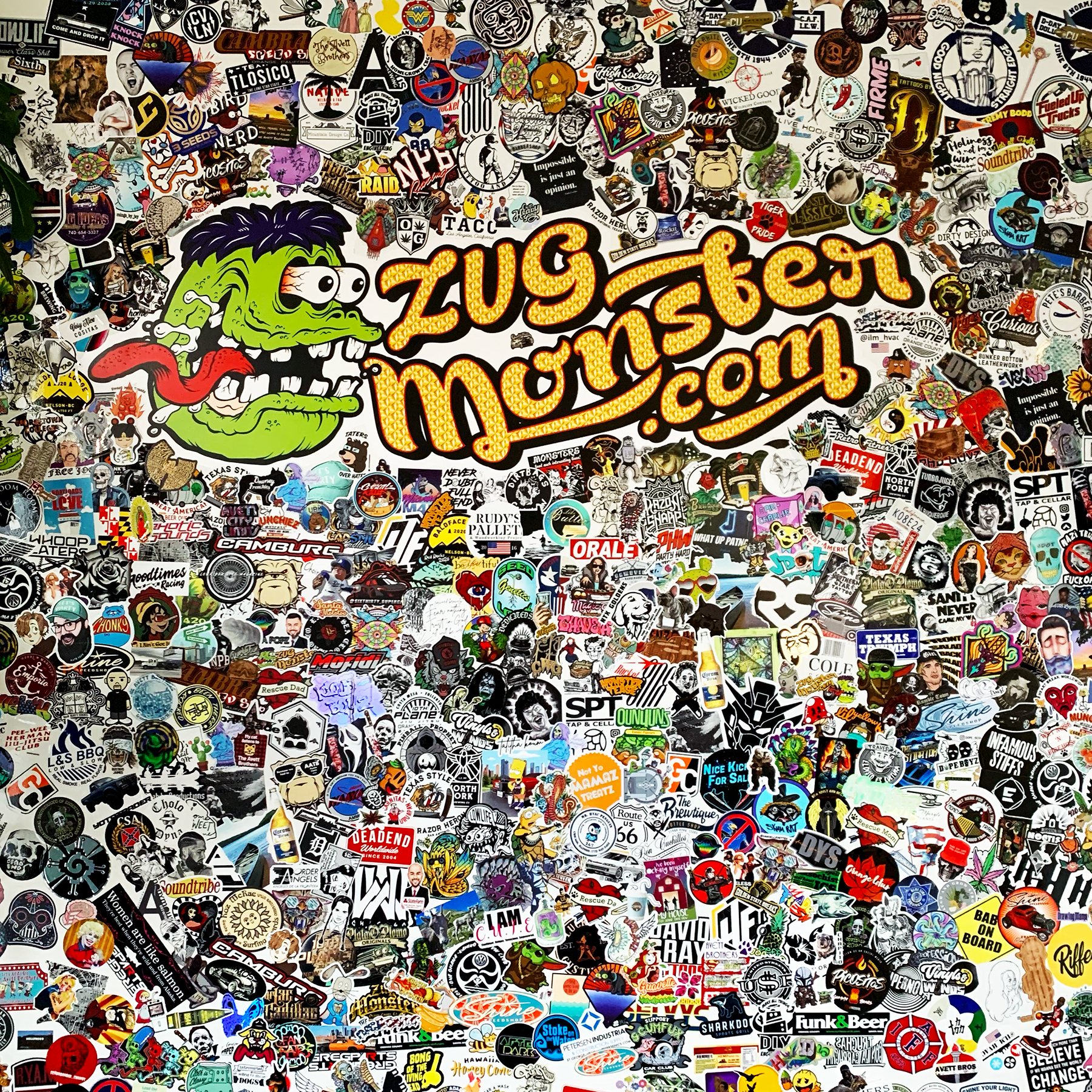 A colorful wall display of custom printed ZUG Monster stickers